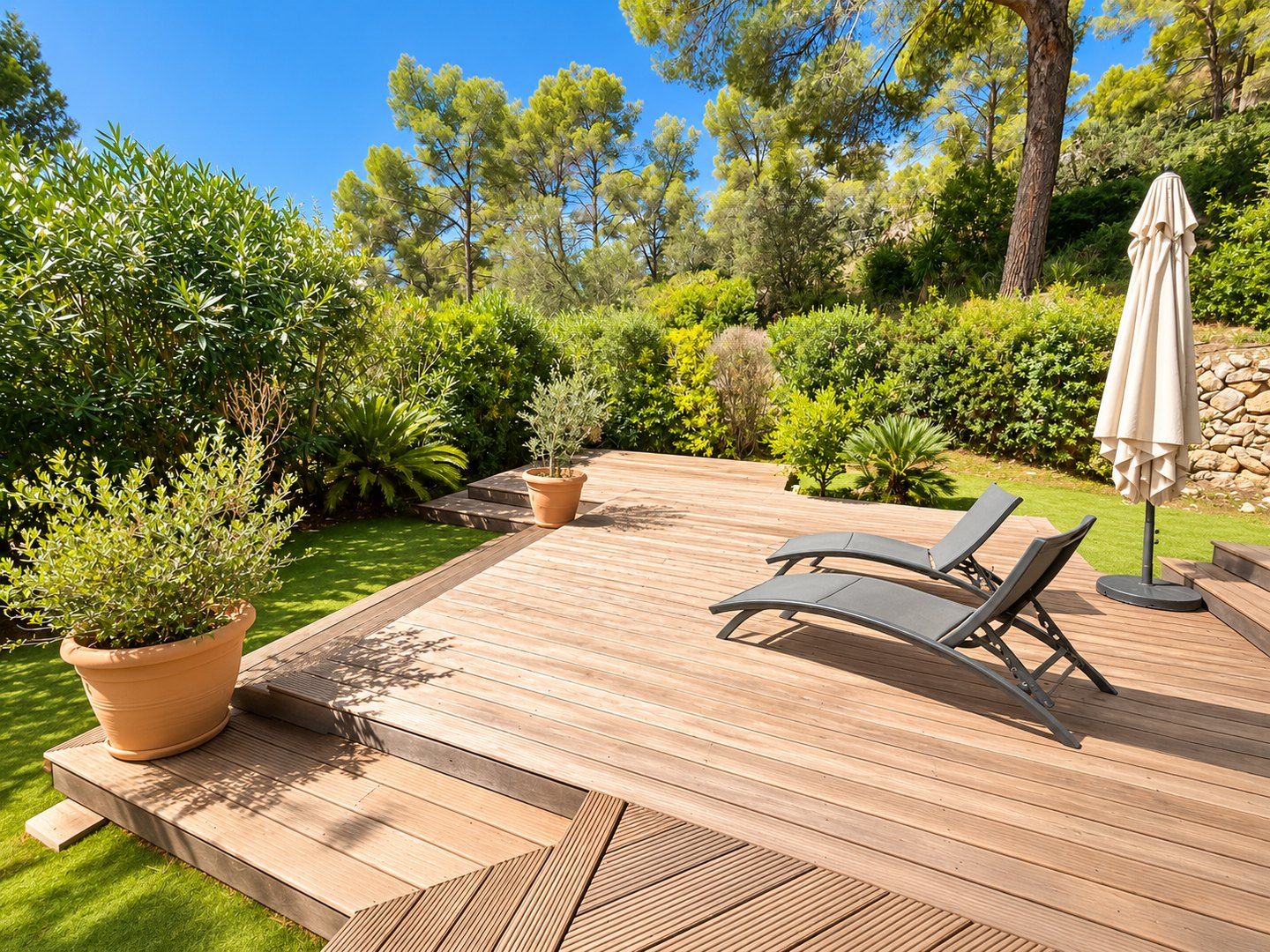 A wooden deck with loungers among the pines